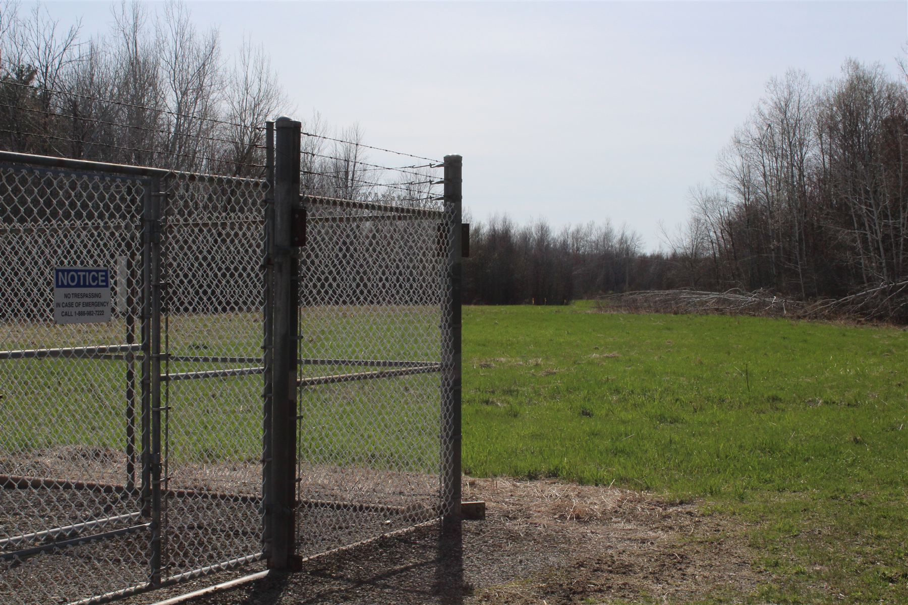 Buried natural gas pipeline corridor with aboveground infrastructure